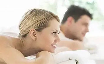 Couples enjoying side-by-side spa massage in a luxury treatment room for relaxation and emotional connection