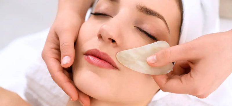 Gua sha facial sculpting and lymphatic drainage massage to lift contours and define facial structure